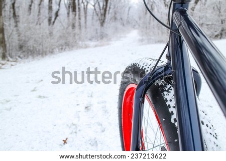 Winter biking on a Fat tire bike. Shallow focus. Focus on Bicycle Fork.