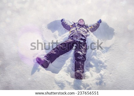 Boy making a snow angel