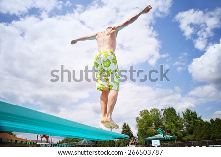 Young man diving off a diving board