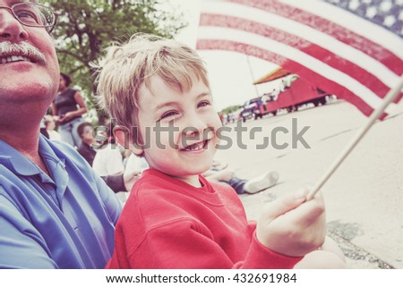 Boy and his father watching a parade