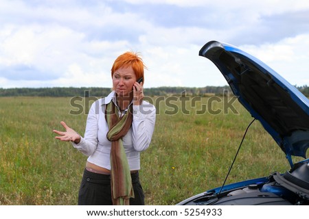 young red-haired woman with her broken car. The girl have a big problem