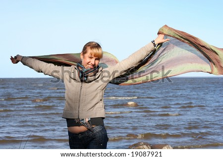 blond woman with scarf. Windy day.