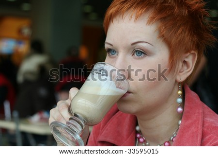 woman drinking coffe in cafe and thoughtfully looks afar