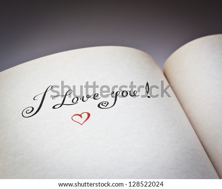 I love you words in the open book with grey background. \
Concept for declaration of love.Also good for postcard.