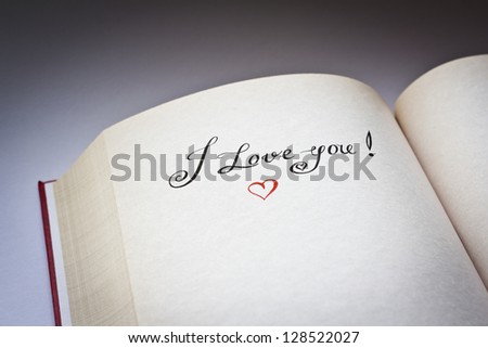 I love you words in the open book with grey background.