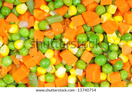 Boiled diced vegetables background with carrot, corn and peas.