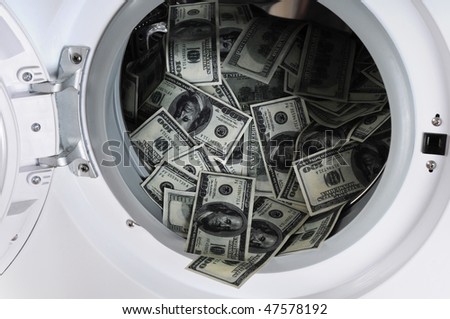 Money laundering concept - 100 dollar bills laundered in a washing machine.
