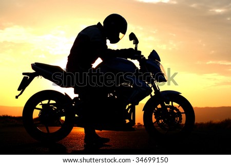 motorcyclist silhouette at the sunset