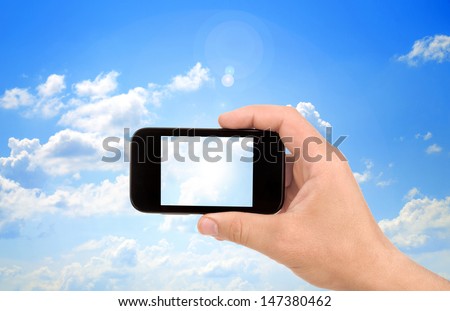 Hand to hold card, mobile phone, tablet PC on blue sky