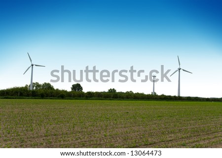 Wind turbines farm on field. Alternative energy source.