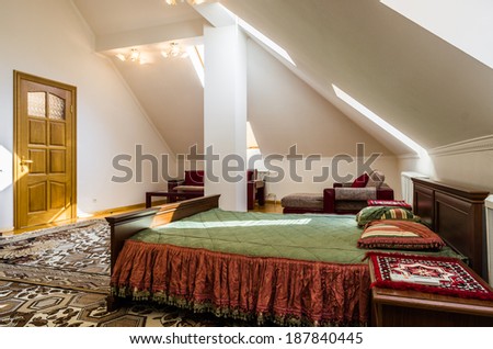 Bedroom attic interior with carpet and table