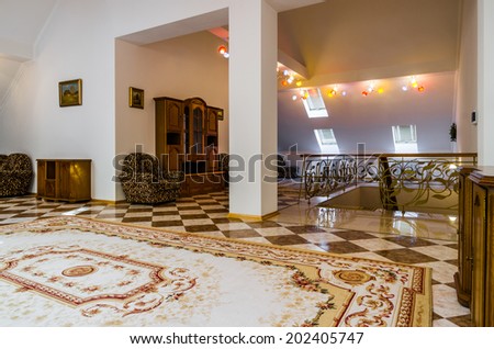 Living room attic interior with carpet and painting