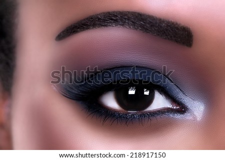 Beautiful African woman wearing eye shadow makeup