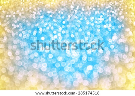 Abstract blue and yellow glitter bokeh sparkle summer background