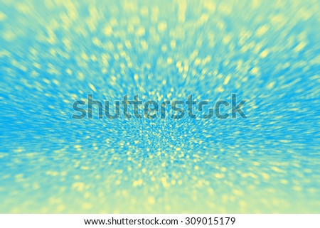 Abstract blue and yellow glitter sparkle bokeh blurred background