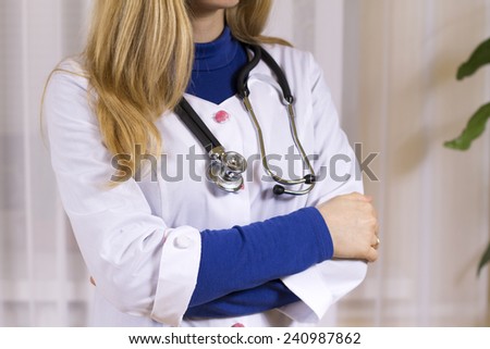 woman doctor in medical cabinet with stethoscope