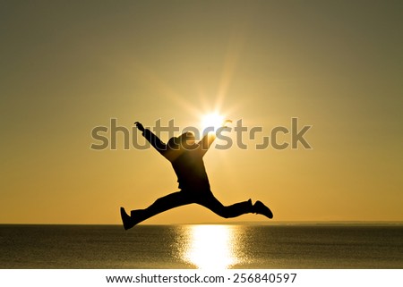 jumping silhouette of man at sunset
