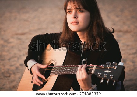 beautiful girl on nature with guitar