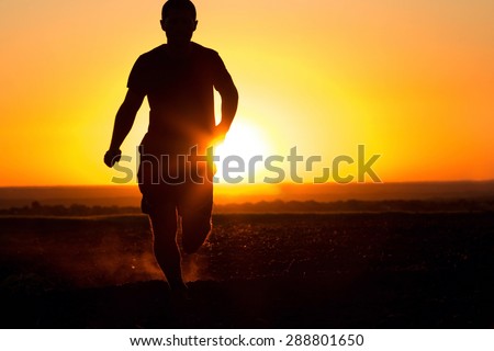Man silhouette running in the field