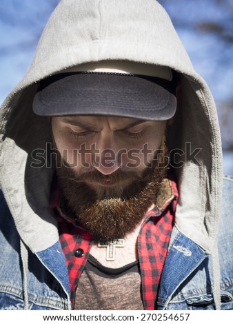 beard face looking down with hat and hood