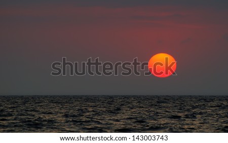 Beautiful sunset bright red sun on the Black sea in the Crimea