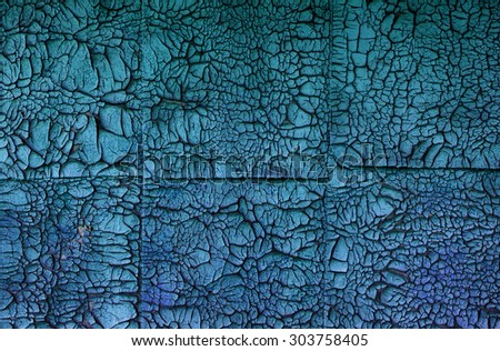 Texture - old flaking paint of blue color on square tiles made of plywood