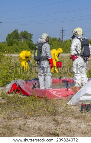 Hazmat team members have been wearing protective suits to protect them from hazardous materials