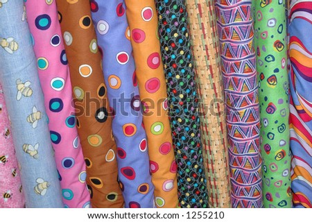 Bolts of patterned quilt fabric.