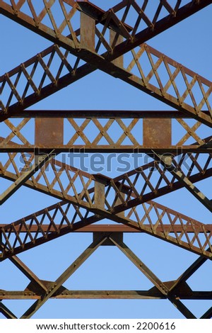 Cross beams on a rusted trestle bridge.