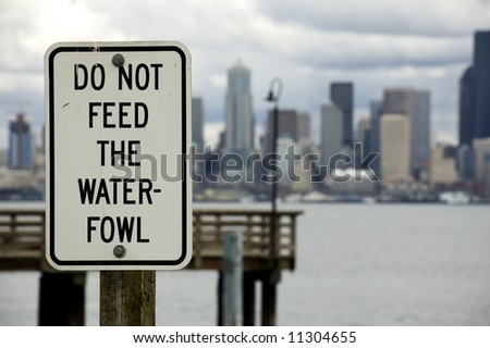 A sign on Alki across from downtown Seattle admonishing tourists not to feed the waterfowl.