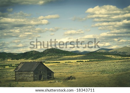 Vintage scene of an old barn in Montana, with cross-processed effect to appear as an old photograph with faded colors.