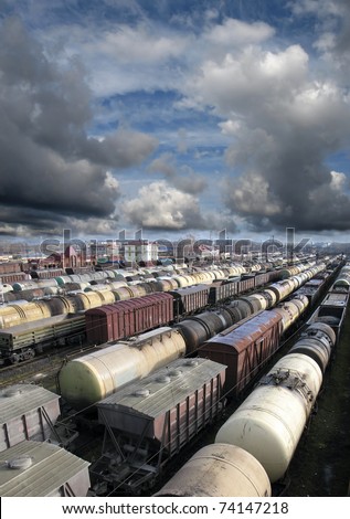 Railroad cars on a railway station. Cargo transportation. Storm clouds above train