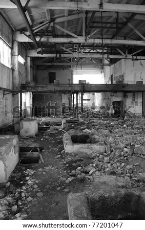 Destroyed factory. Ruins of a house. Abandoned building. Black and white photo