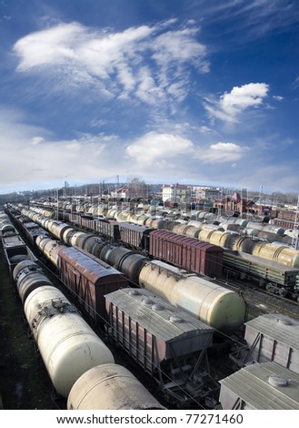 Railroad cars on a railway station. Cargo transportation. Work of industry. Urban scene. Wide angle. Panoramic view