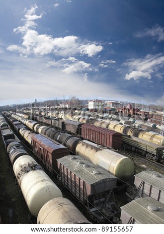 Railroad cars on a railway station. Cargo transportation. Work of industry. Urban scene. Train. Wide angle. Panoramic view