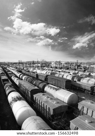 Railroad cars on a railway station. Cargo transportation. Work of industry. Urban scene. Train. Black and white photo