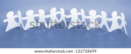 Row of Paper Chain Dolls Holding Hands on Blue Background
