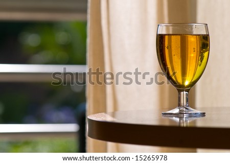 Glass of cider with smooth back light giving pleasant warm feeling