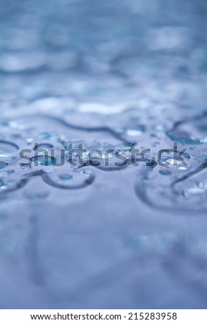 Water drops on the table in the garden during summer in Scotland.