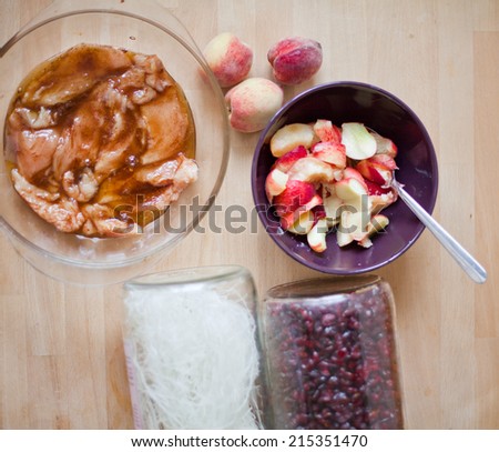 Rice pasta with sweet and sour chicken, plum, peach, cranberry.Sweet and sour chicken on rice pasta with fruits, basil, almond, peach, plum, nuts, honey. Pasta from rice.