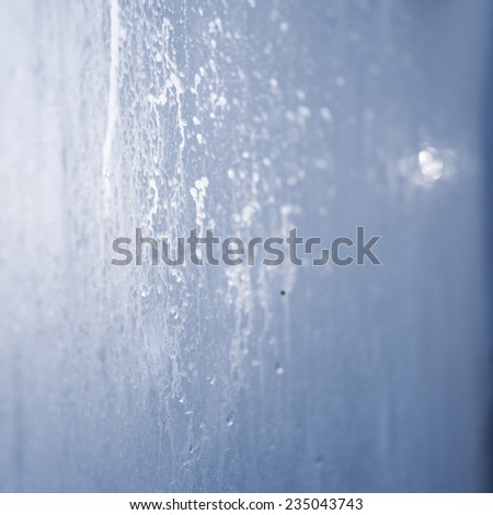 Frozen water drops on a glass. Silver frost on a window. Winter, december, Christmas. Background, Postcard, Nobody. Transparent, drops or ice on a surface.