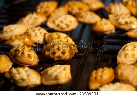 Traditional smoked sheep cheese called oscypek. A lot of small pieces of cheese on a grill. Christmas in Poland, tradition in mountains.