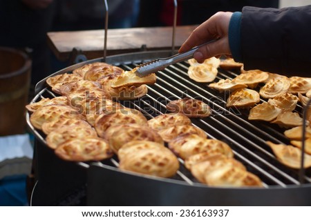 Traditional smoked sheep cheese called oscypek. A lot of small pieces of cheese on a grill, spit, broach. Christmas in Poland, tradition in mountains.