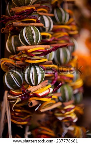 Christmas decorations made with dried fruits. Christmas garland, chaplet to decorate christmas tree. Home-made decorations sold during Christmas market.
