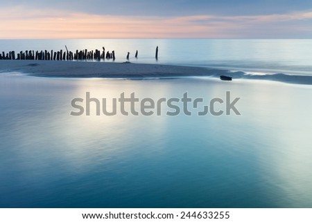 Mediterranean Sea coast during sunset.View on a breakwater Sand seaside and sea. Holidays in Spain. Landscape view. NAture, wildlife. Summer.