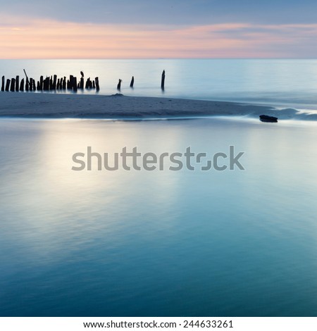 Mediterranean Sea coast during sunset.View on a breakwater Sand seaside and sea. Holidays in Spain. Landscape view. NAture, wildlife. Summer.