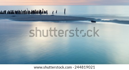 Mediterranean Sea coast during sunset.View on a breakwater Sand seaside and sea. Holidays in Spain. Landscape view. Nature, wildlife. Summer.
