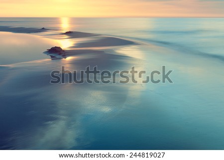 Mediterranean Sea coast during sunset. Sand seaside and sea. Holidays in Spain. Landscape view. Nature, wildlife. Summer.