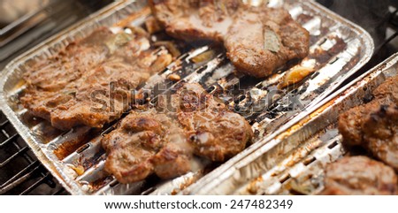 Chuck steak on grill. Barbecue in a garden. pork, beef meat. Grilled meat. Food, restaurant, menu. Nobody, macro perspective.