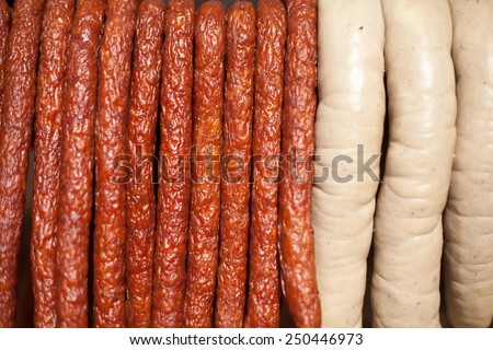 Home-made smoked thin sausages and white sausages prepared by butcher. Presented in wooden basket. Sell in fair, markets or butchery shops. Nobody, healthy, organic food. meet with herbs and spices.